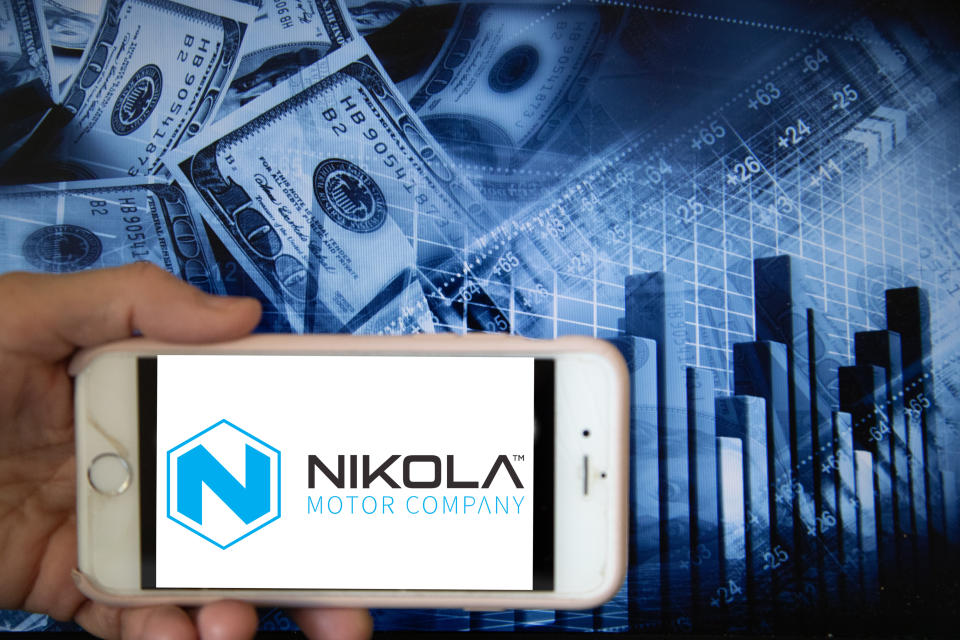 In this illustration is displayed on a smartphone's screen the company logo of Nikola Corporation, which specialises in hydrogen-powered truck design and manufacture, is shown on the screen of a smartphone in front of a blue backdrop of the global stock markets and worldwide indices in Frankfurt, Germany, on 12th June, 2020. It is one of the global companies that develops and manufactures fuel cell products powered by hydrogen in the current alternative energy market. (Photo Illustration by Alexander Pohl/NurPhoto via Getty Images)