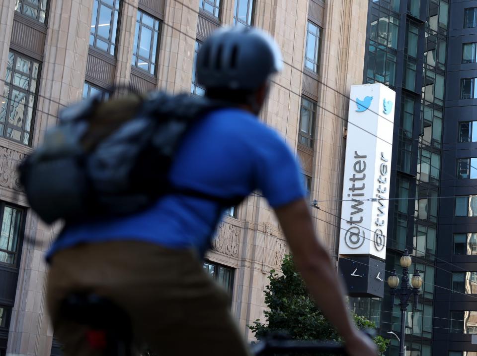 A cyclist passes Twitter's HQ in San Francisco