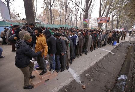 Indian policemen frisk Kashmiri men at the entrance of the cricket stadium where Indian Prime Minister Narendra Modi is scheduled to address a rally in Srinagar, November 7, 2015. REUTERS/Danish Ismail