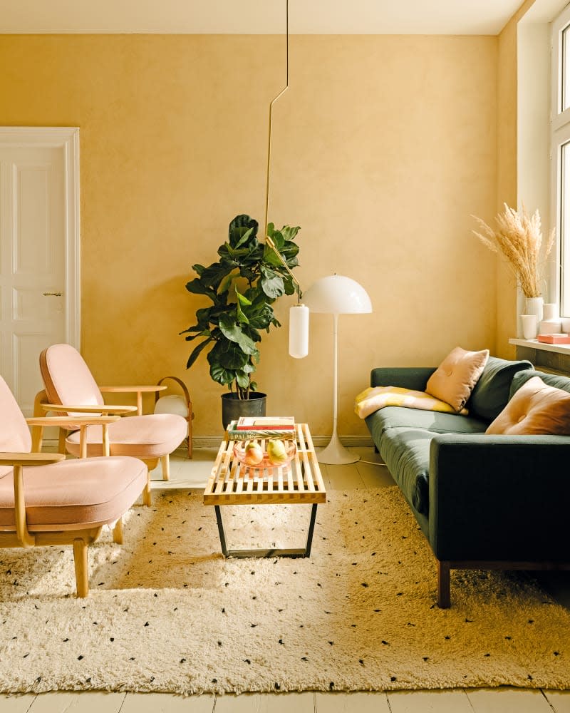 The walls in the living room are painted in clay from Nen-Do. Jaime Hayon’s Fred armchairs and a Bolia sofa flank George Nelson’s bench for Vitra. The floor lamp is by Louis Poulsen.