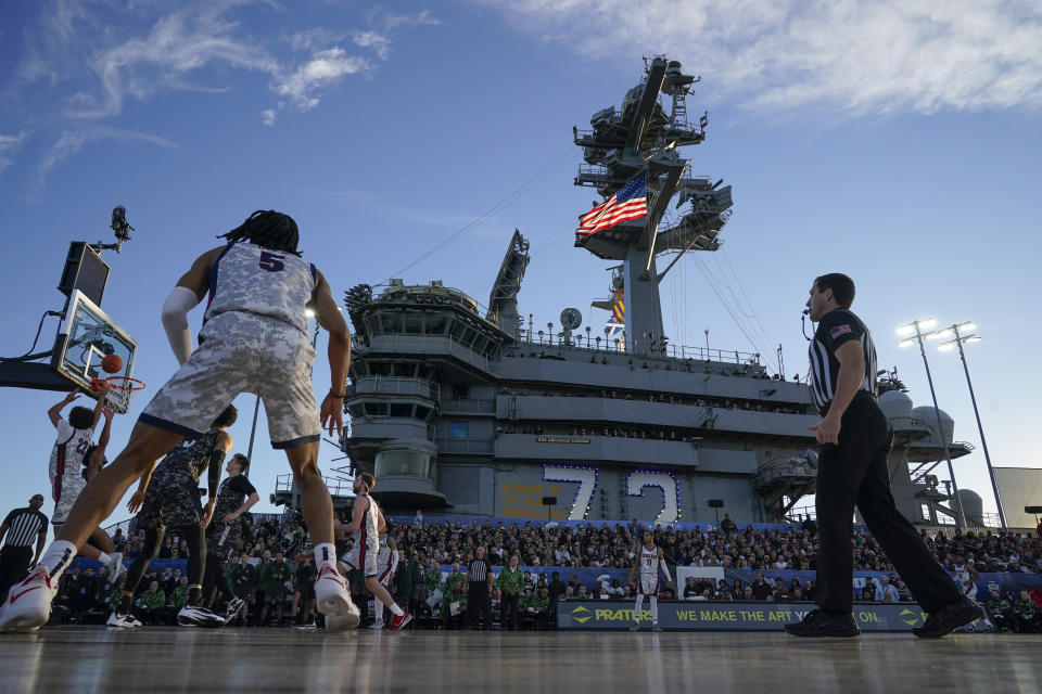 Gonzaga forward Anton Watson, left, shoots during the first half of the Carrier Classic NCAA college basketball game against Michigan State aboard the USS Abraham Lincoln, Friday, Nov. 11, 2022, in Coronado, Calif. (AP Photo/Gregory Bull)