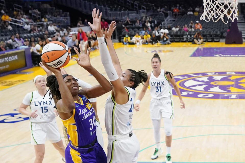 Los Angeles Sparks forward Nneka Ogwumike (30) shoots as Minnesota Lynx forward Napheesa Collier (24) defends during the first half of a WNBA basketball game Tuesday, June 20, 2023, in Los Angeles. (AP Photo/Mark J. Terrill)