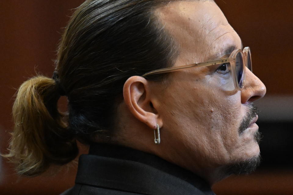 Actor Johnny Depp listens in the courtroom at the Fairfax County Circuit Court in Fairfax, Va., Tuesday May 3, 2022. Depp sued his ex-wife Amber Heard for libel in Fairfax County Circuit Court after she wrote an op-ed piece in The Washington Post in 2018 referring to herself as a "public figure representing domestic abuse." (Jim Watson/Pool photo via AP)