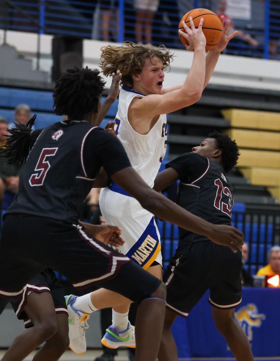 Ari Smith (3), of Martin County, gets double-teamed by Jeremy Innocent (5) and Tariq Mcleod (13), of Lake Worth, in a high school boys basketball game, Tuesday, Dec. 5, 2023, at Martin County High School.