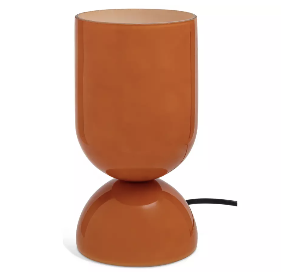 Orange glass table lamp on a white background