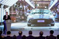 Tesla Inc CEO Elon Musk speaks next to a screen showing an image of Tesla Model 3 car during an opening ceremony for Tesla China-made Model Y program in Shanghai