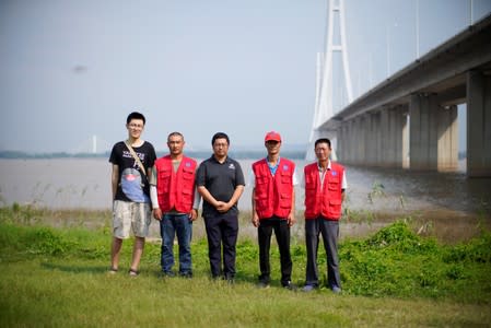 Conservationists pose for picture at the Yangtze river near the city of Nanjing