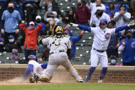 Pittsburgh Pirates catcher Michael Perez (5) looks on as Chicago Cubs' Jason Heyward (22) scores during the seventh inning of a baseball game, Saturday, May 8, 2021, in Chicago. (AP Photo/Matt Marton)