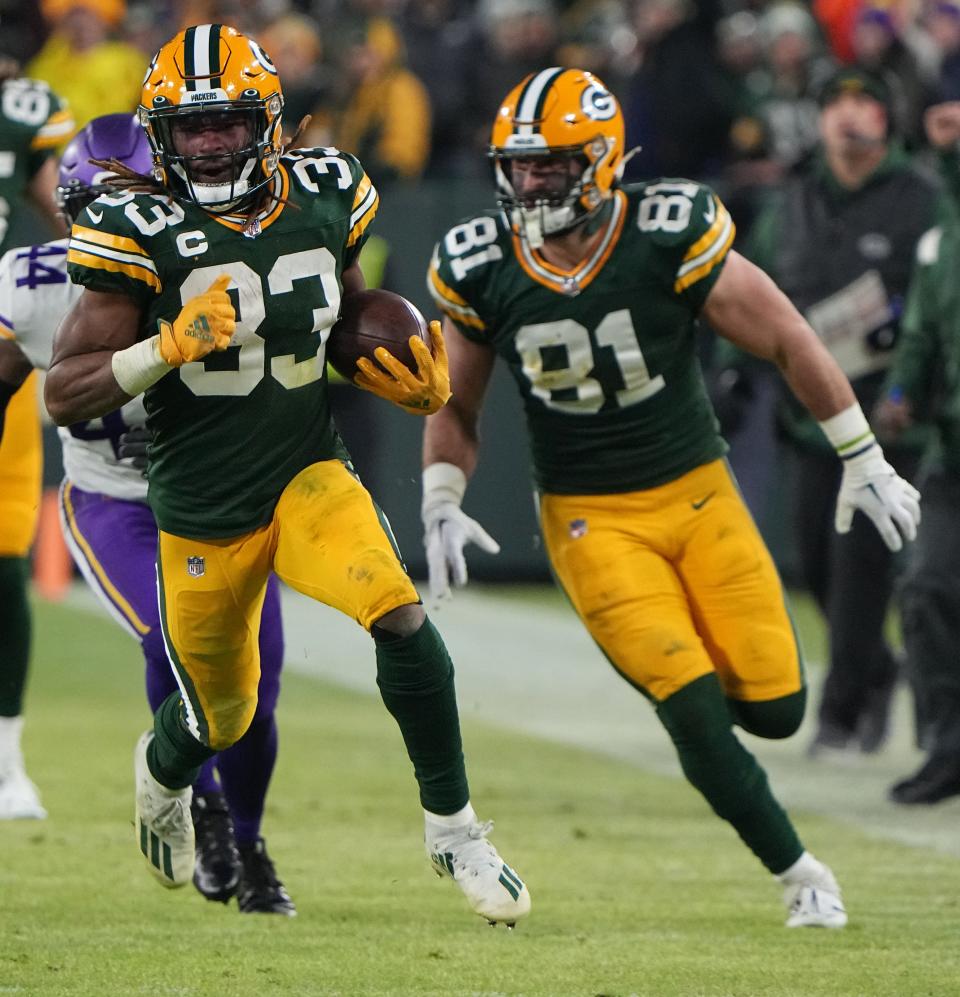 Green Bay Packers running back Aaron Jones (33) runs for 31 yards during the second quarter against the Minnesota Vikings Sunday at Lambeau Field.