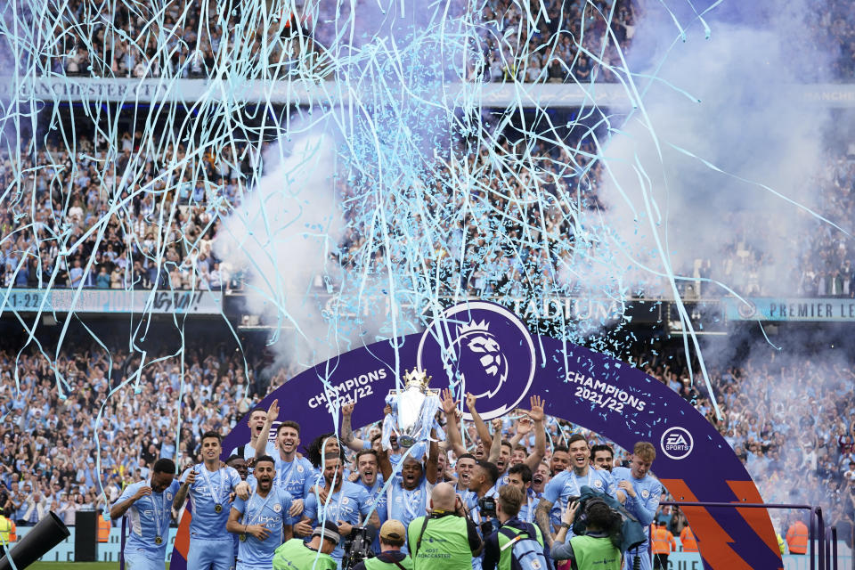 Manchester City players celebrate with trophy after winning the 2022 English Premier League title at the Etihad Stadium in Manchester, England, Sunday, May 22, 2022. (AP Photo/Dave Thompson)