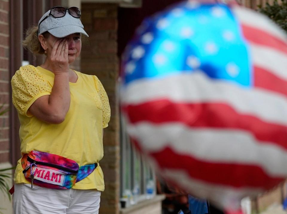 Six people were killed and at least 36 more injured after a gunman perched on a rooftop opened fire on families waving flags and children riding bikes at the Independence Day event in the Chicago suburb (Nam Y Huh/AP)