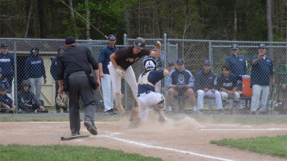 Cherokee's Leo Bluestein (left) leaps to avoid the tag of St. Augustine Prep catcher Austin Sofran in the sixth inning of  their Diamond Classic quarterfinal meeting on Tuesday, May 10, 2022, at St. Augustine Prep.