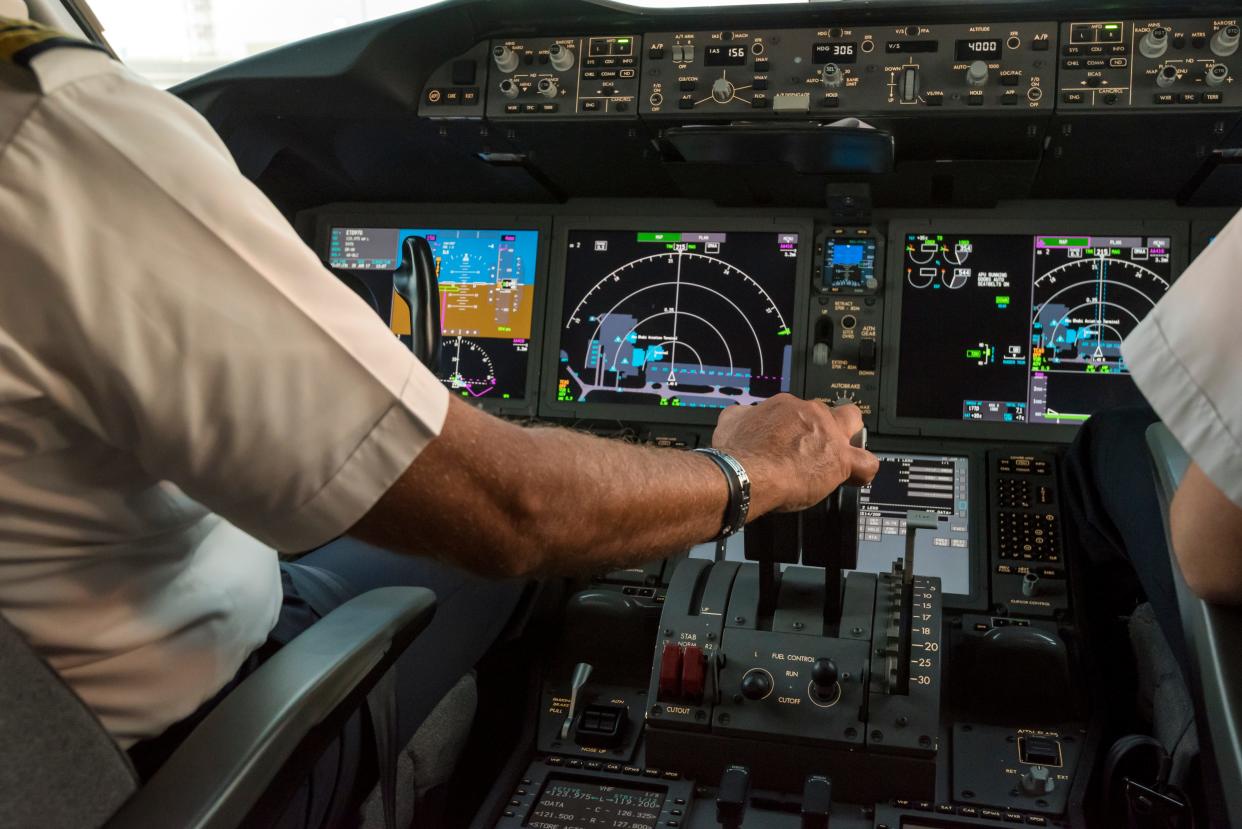 A pilot in the cockpit of an aircraft.