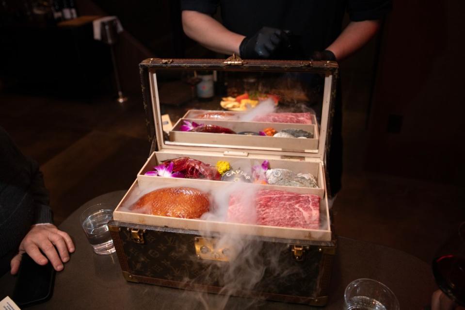 Dinner — which includes choices of caviar, oysters, duck, American Wagyu and other fine delicacies — is presented in Louis Vuitton suitcases over smoking dry ice. Brian Zak/NY Post