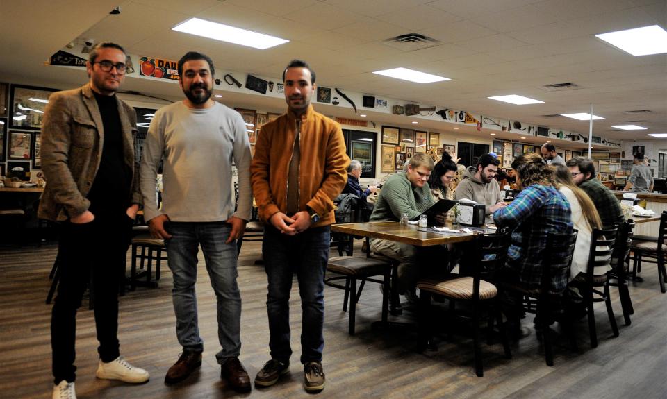 From left, Edris Akbari, Khaiber Shafaq, and Tariq Pakzad inside the dining room at Pamir Afghan restaurant, which occupies the Windy Hollow Biscuit House in Owensboro on Saturday and Sunday evenings, on Saturday, Jan. 28, 2023.
