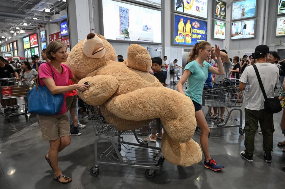 TOPSHOT - A woman pushes a trolley with a teddy bear at the first Costco outlet in China, on the stores opening day in Shanghai on August 27, 2019. - China has proved a brutal battleground for overseas food retailers in recent years, with many failing to understand consumer habits and tastes as well as local competitors building a stronger presence. (Photo by HECTOR RETAMAL / AFP)        (Photo credit should read HECTOR RETAMAL/AFP/Getty Images)