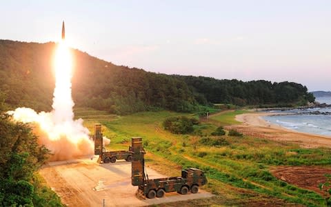 South Korea's missile system firing Hyunmu-2 missile into the East Sea  - Credit: AFP/South Korean Defence Ministry