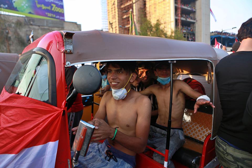 Volunteer Tuk-tuk drivers prepare to evacuate wounded anti-government protesters during ongoing protests in Baghdad, Iraq, Wednesday, Oct. 30, 2019. Anti-government protests in Iraq gained momentum Wednesday with tens of thousands of people gathered in a central square in Baghdad and across much of the country's Shiite-majority central southern provinces. (AP Photo/Khalid Mohammed)