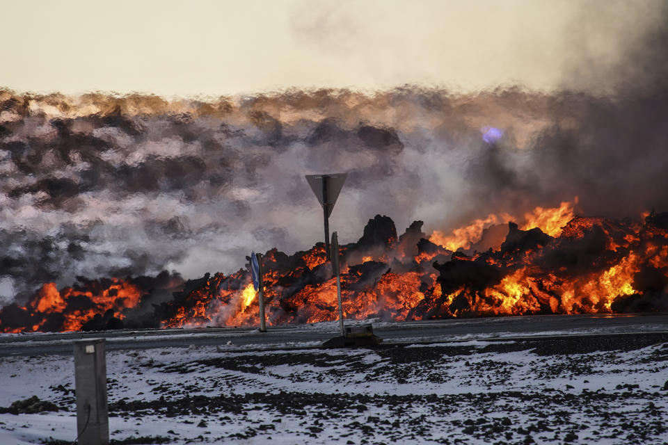 Lava reaches close to the road to Grindavík, near the exit for the blue lagoon, in Grindavík, Iceland, Thursday, Feb. 8, 2024. A volcano in southwestern Iceland has erupted for the third time since December and sent jets of lava into the sky. The eruption on Thursday morning triggered the evacuation the Blue Lagoon spa which is one of the island nation’s biggest tourist attractions. (AP Photo /Marco Di Marco)