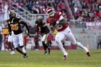 Arkansas receiver Treylon Burks (16) makes a catch in front of Missouri defensive back DJ Jackson (36) during the first half of an NCAA college football game Friday, Nov. 26, 2021, in Fayetteville, Ark. (AP Photo/Michael Woods)