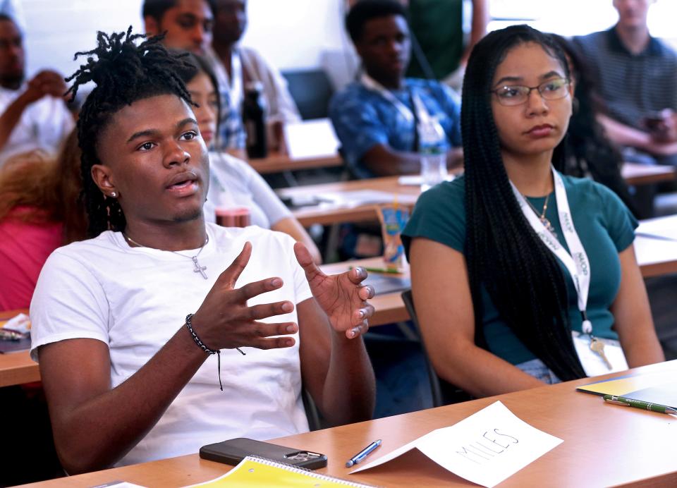 Miles Campbell, 17, left,  posed a question to Milwaukee Bucks player Pat Connaughton about how to invest in real estate with limited funds at the NAIOP Wisconsin and Marquette University Center for Real Estate Launch MKE CRE Immersion Program on Monday,  July 18, 2022 at Marquette University.  Connaughton whose firm is Three Leaf Development,  was one of the presenters who shared his expertise on the real estate industry Campbell and other teens.