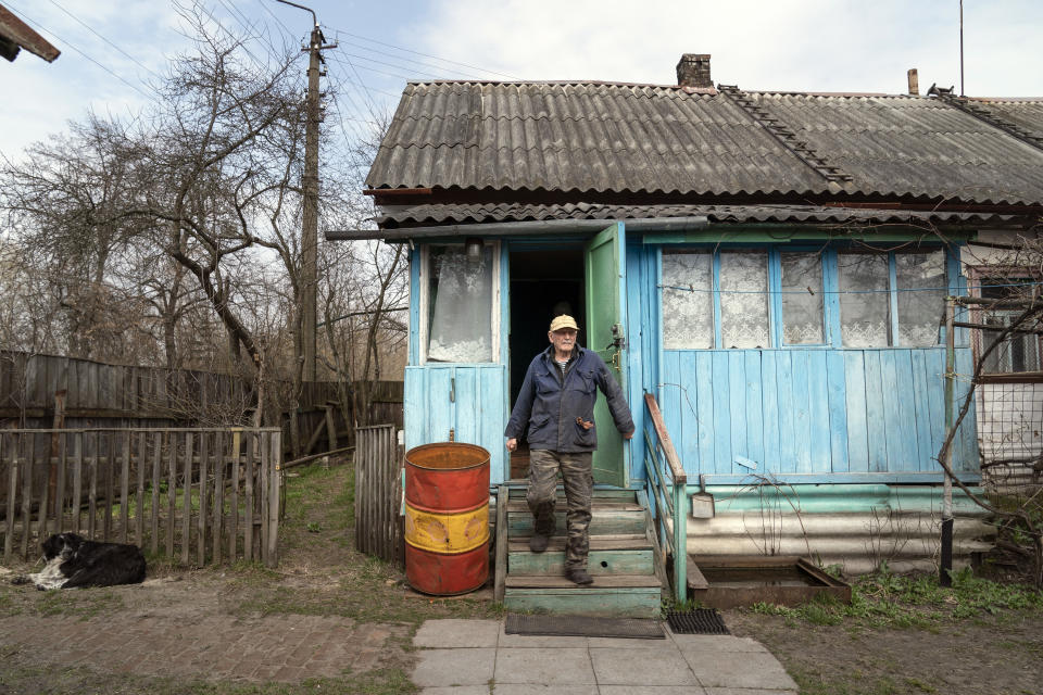 Yevgeny Markevich, a 85-year-old former teacher, leaves his house at the Chernobyl exclusion zone, Ukraine, Wednesday, April 14, 2021. Markevich said "It's a great happiness to live at home, but it's sad that it's not as it used to be." Today, he grows potatoes and cucumbers on his garden plot, which he takes for tests "in order to partially protect myself." The vast and empty Chernobyl Exclusion Zone around the site of the world’s worst nuclear accident is a baleful monument to human mistakes. Yet 35 years after a power plant reactor exploded, Ukrainians also look to it for inspiration, solace and income. (AP Photo/Evgeniy Maloletka)