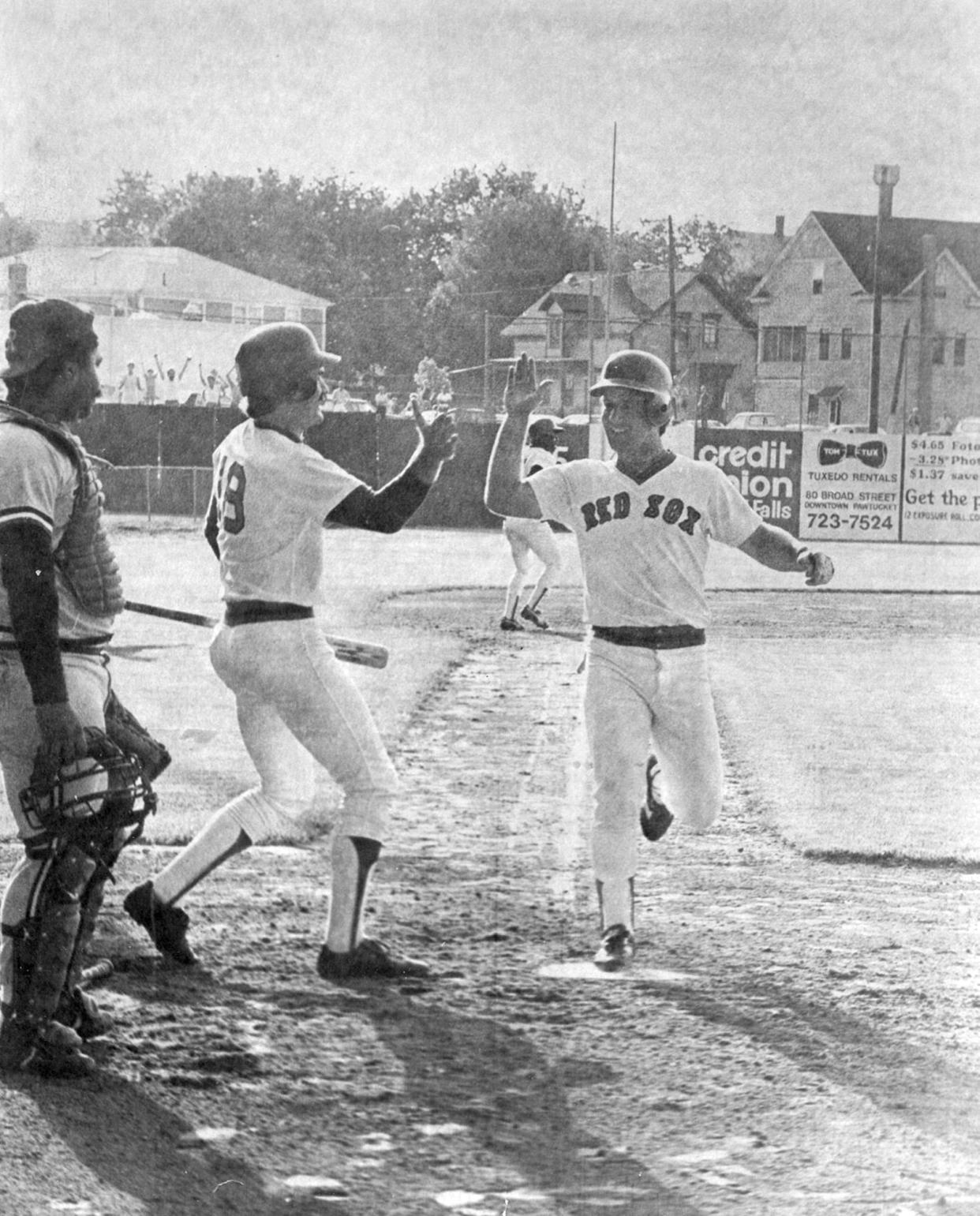 Marty Barrett is greeted by Wade Boggs at home plate as he scores the winning run in the 33rd inning to beat the Rochester Red Wings 3-2, completing the longest game in professional baseball at McCoy Stadium on June 23, 1981.