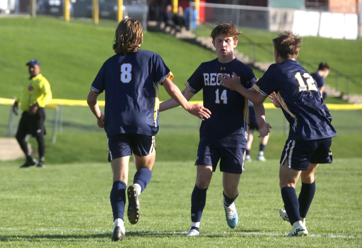 From left, Regina Catholic’s Quinn Warren (8), Jack Hoover (14) and Evan White (12) react after Warren’s goal in the second half against Beckman Catholic on Wednesday.