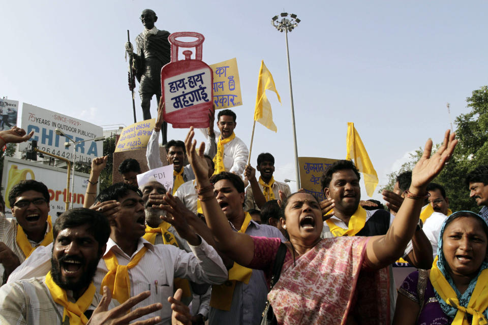 Indian members and supporters of Gujarat Parivartan Party (GPP) shout slogans during a protest in Ahmedabad, India, Saturday, Sept. 15, 2012. Angry Indian opposition parties protested on Saturday against the government's decision to open the country's huge retail market to foreign retailers, a hike in the price of diesel fuel and reduction in cooking gas subsidies. The mock cooking gas cylinder reads as "Down with price rise." (AP Photo/Ajit Solanki)