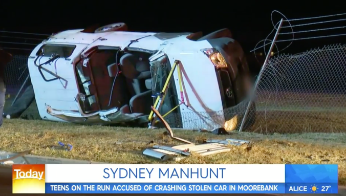 A Toyota Hilux ute carrying eight people is turned on its side at the scene of a crash. Eight people were inside the vehicle at the time.