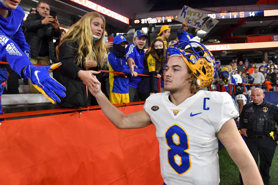 Pittsburgh quarterback Kenny Pickett (8) celebrates with fans after a win against Syracuse in an NCAA college football game in Syracuse, N.Y., Saturday, Nov. 27, 2021. (AP Photo/Adrian Kraus)