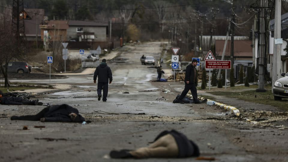 In this photo taken on April 2, 2022, bodies of civilians lie on Yablunska street in Bucha, northwest of Kyiv, after the Russian army pulled back from the city. - Ronaldo Schemidt/AFP/Getty Images