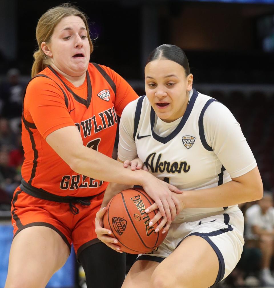 Bowling Green's Morgan Sharps and Akron's Kendall Miller battle for possession in a Mid American Conference Tournament quarterfinal game on Wednesday March 9, 2022 in Cleveland, Ohio, at Rocket Mortgage FieldHouse.