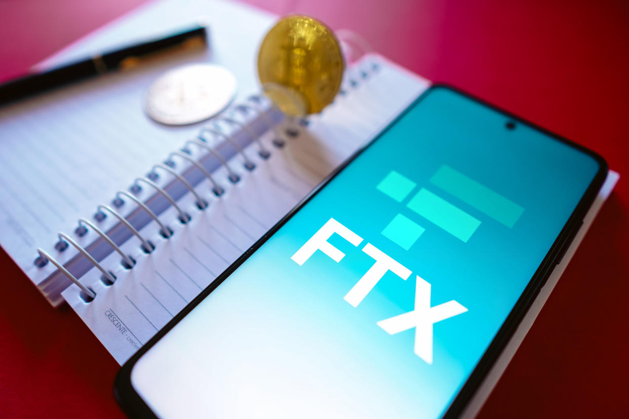 BRAZIL - 2022/07/19: In this photo illustration, the FTX Crypto Derivatives Exchange logo is displayed on a smartphone screen, on the side of Bitcoin cryptocurrencies. (Photo Illustration by Rafael Henrique/SOPA Images/LightRocket via Getty Images)