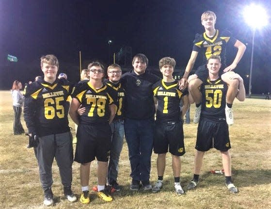 Bellevue seniors celebrate after the game as Bellevue's varsity football team played a flag football game against members of the Bellevue police department and other adults Friday.