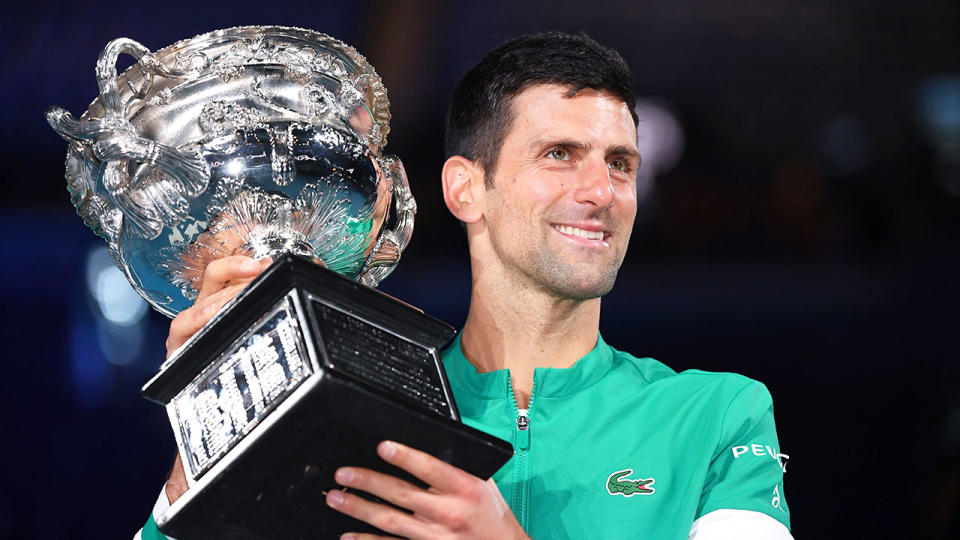 Pictured here, Novak Djokovic holds the Australian Open trophy he won for the ninth time in 2021.