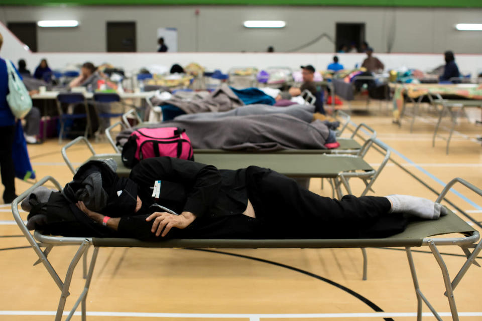 Evacuee sleeps at a community center