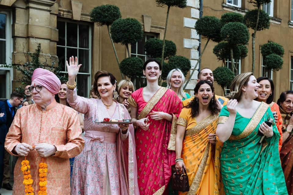 My family and bridesmaids welcoming the procession at the entrance of Aynhoe.