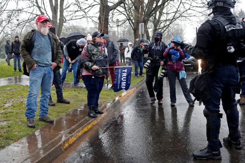 Supporters of U.S. President Donald Trump confront police at a rally in support of Trump at the Oregon State Capitol in Salem