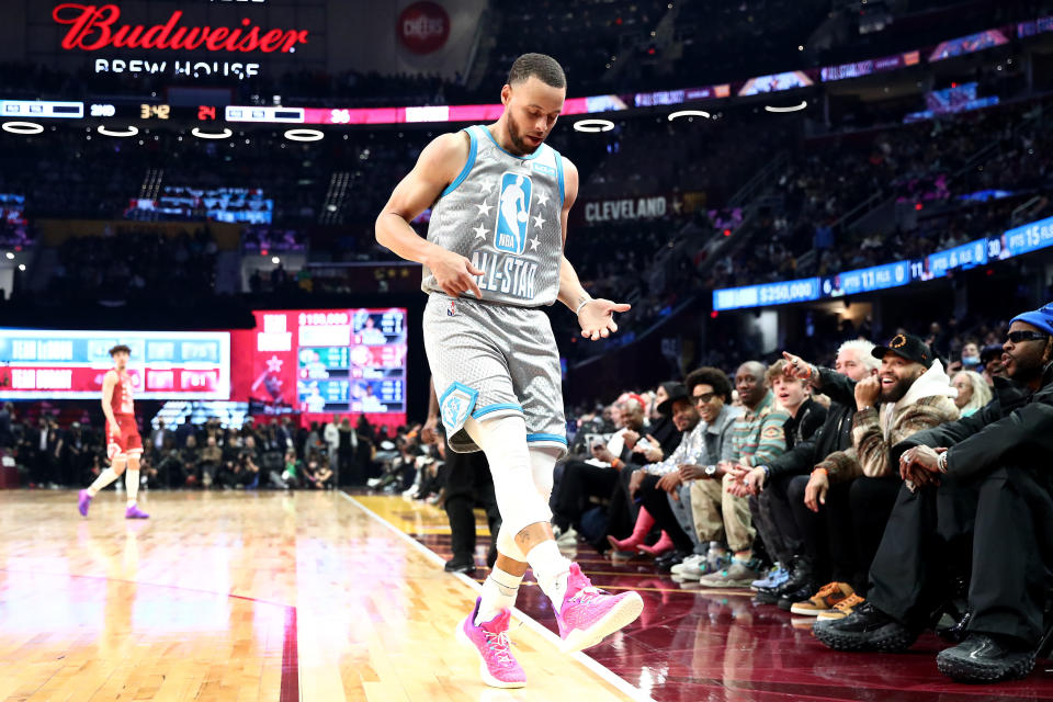 Golden State Warriors superstar Stephen Curry strums an air guitar after one of his record-breaking 16 3-pointers in the 2022 NBA All-Star Game. (Tim Nwachukwu/Getty Images)