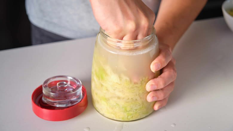 Man pressing sauerkraut