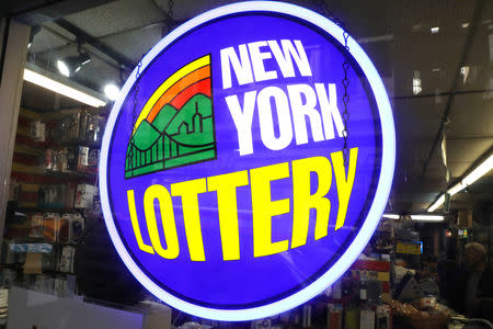 A sign displays the availability of lottery tickets at a store in midtown Manhattan in New York, U.S., October 19, 2018. REUTERS/Mike Sugar