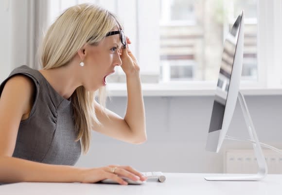 Shocked woman looking at her computer.