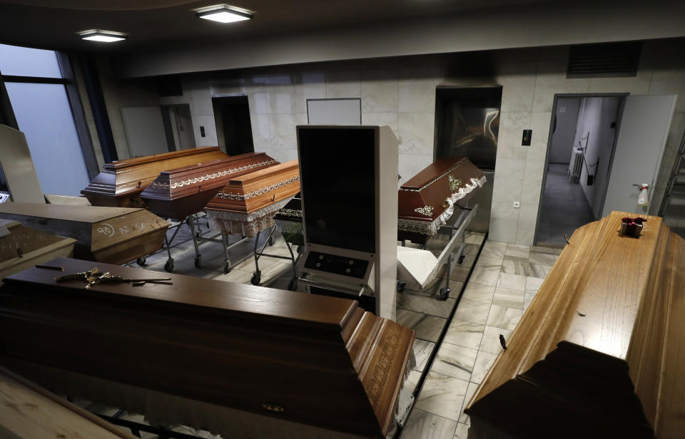 Caskets are prepared to be incinerated at a crematorium in Ostrava, Czech Republic, Thursday, Jan. 7, 2021. The biggest crematorium in the Czech Republic has been overwhelmed by mounting numbers of pandemic victims. With new confirmed COVID-19 infections around record highs, the situation looks set to worsen. Authorities in the northeastern city of Ostrava have been speeding up plans to build a fourth furnace but, in the meantime, have sought help from the government’s central crisis committee for pandemic coordination. (AP Photo/Petr David Josek)