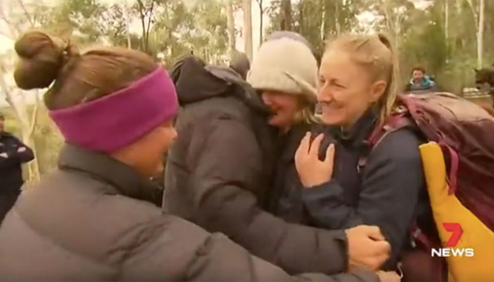 Emotional friends and relatives hug lost horse rider Narelle Davies after she is found. Source: 7 News