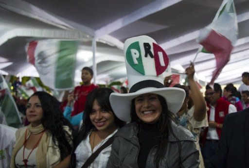 Supporters of Enrique Pena Nieto celebrate at party headquarters in Mexico City on July 1 as they wait for the official result of the presidential election. His losing opponent says voters were swayed by gifts like department store gift cards, food, and building material