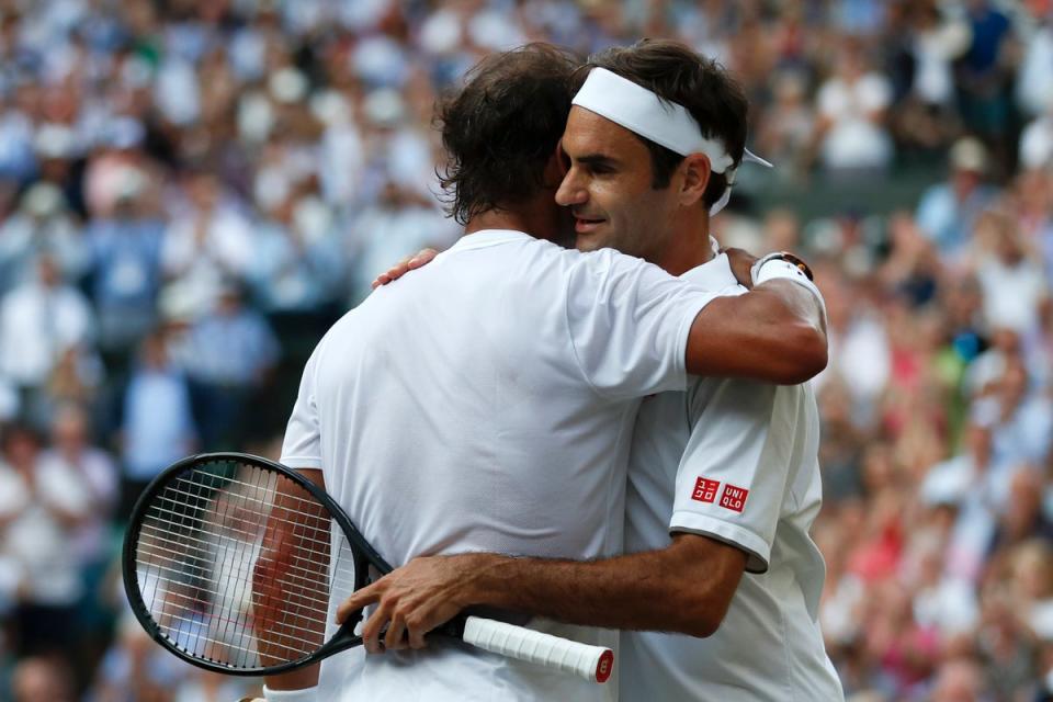 Roger Federer (right) and Rafael Nadal embrace after their last meeting at Wimbledon in 2019 (Adrian Dennis/PA) (PA Archive)