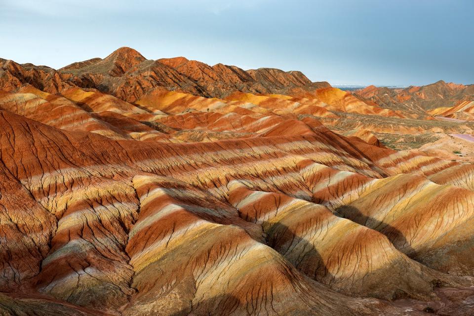 Zhangye Danxia National Geopark, Gansu, China. Colorful landscape of rainbow mountains. Walking paths around sandstone rock formation at Zhangye National Geological Park.