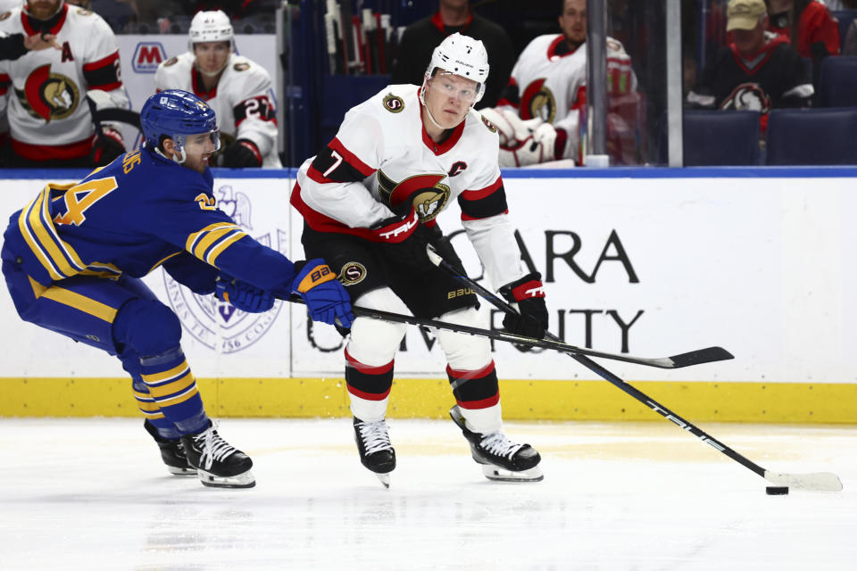 Ottawa Senators left wing Brady Tkachuk (7) is stick checked by Buffalo Sabres center Dylan Cozens (24) during the second period of an NHL hockey game Wednesday, March 27, 2024, in Buffalo, N.Y. (AP Photo/Jeffrey T. Barnes)