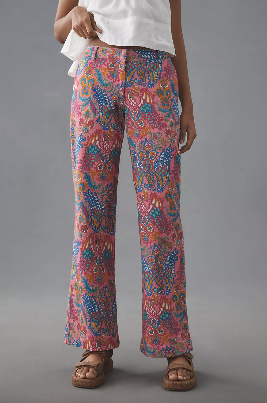 woman wearing pink, blue pattern Love The Label Printed Low-Rise Flare Pants (photo via Anthropologie)